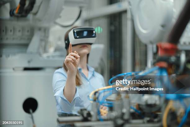 Female Engineer Using Vr In Modern Industrial Factory With Robotics ...