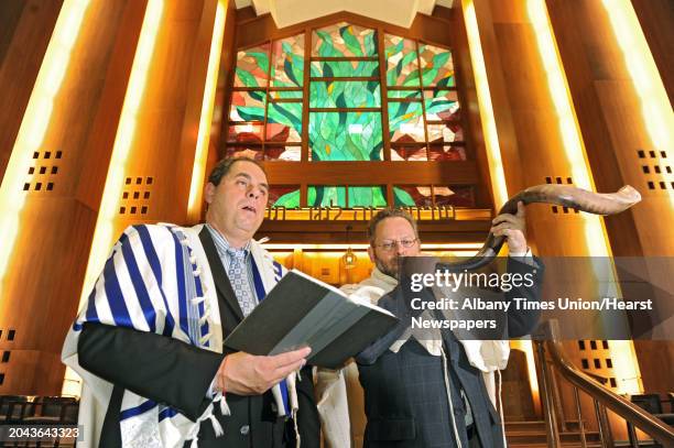 Cantor Rogerio Marx sings while Rabbi David Eligberg blows the shofar at Temple Israel on Tuesday, Sept. 3, 2013 in Albany, N.Y. Rosh Hashanah begins...