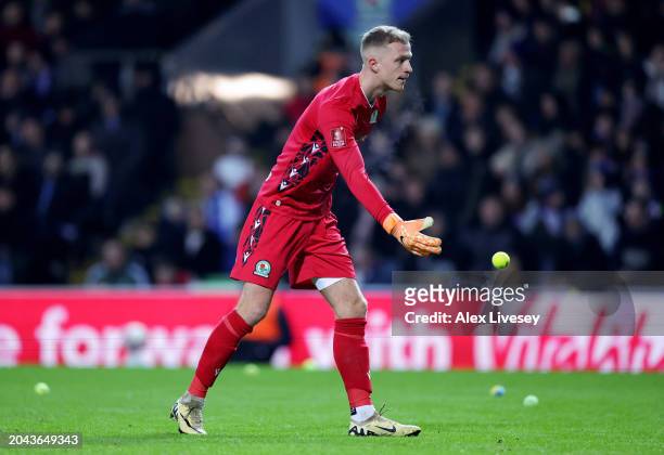 Aynsley Pears of Blackburn Rovers removes tennis balls thrown onto the pitch by supporters during the Emirates FA Cup Fifth Round match between...