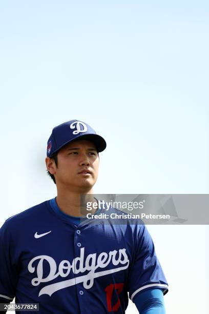 Shohei Ohtani of the Los Angeles Dodgers looks on prior to a game against the Chicago White Sox at Camelback Ranch on February 27, 2024 in Glendale,...
