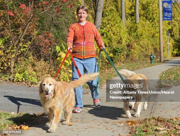 Nancy Horn of Albany walks her two dogs Moke, left, and Fritter along New Scotland Ave. On Monday, Oct. 21, 2013 in Albany, N.Y.