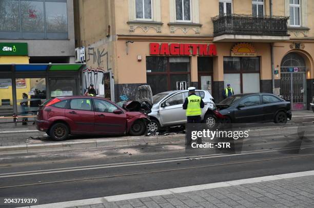 Members of the emergency services work at the scene after a car drove through a group of pedestrians in Szczecin, northeastern Poland on March 1,...