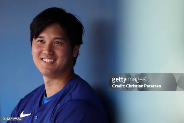 Shohei Ohtani of the Los Angeles Dodgers looks on in the dugout during a game against the Chicago White Sox at Camelback Ranch on February 27, 2024...