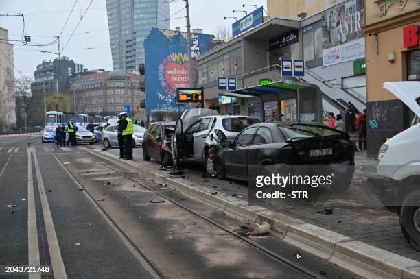 Members of the emergency services work at the scene after a car drove through a group of pedestrians in Szczecin, northeastern Poland on March 1,...