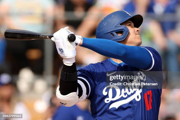 Shohei Ohtani of the Los Angeles Dodgers hits a two-run home run in the fifth inning inning during a game against the Chicago White Sox at Camelback...