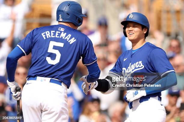 Shohei Ohtani celebrates with Freddie Freeman of the Los Angeles Dodgers after hitting a two-run home run in the fifth inning inning during a game...
