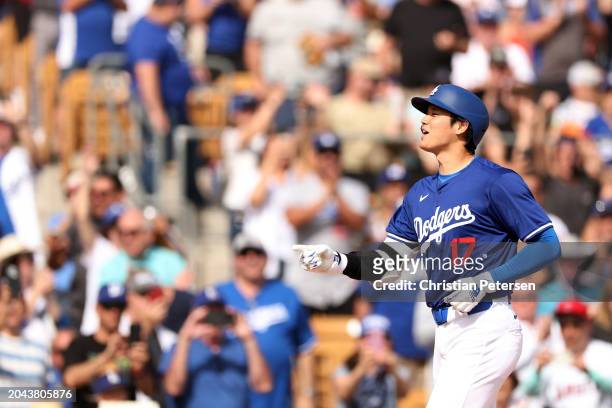Shohei Ohtani of the Los Angeles Dodgers smiles after hitting a two-run home run in the fifth inning inning during a game against the Chicago White...