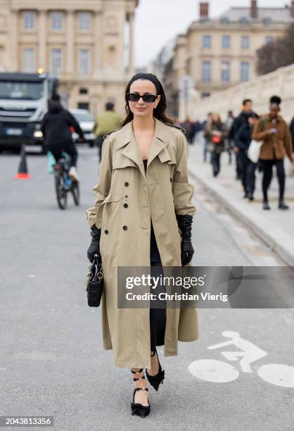 Zina Charkoplia wears trench coat, black gloves, bag, shoes outside Dior during the Womenswear Fall/Winter 2024/2025 as part of Paris Fashion Week on...