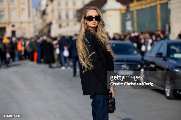 Romee Strijd wears black blazer, white shirt, denim jeans, black bag, sunglasses outside Dior during the Womenswear Fall/Winter 2024/2025 as part of...