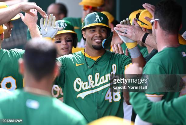 Darell Hernaiz of the Oakland Athletics celebrates with teammates in the dugout after hitting an RBI sacrifice fly against the Cleveland Guardians...