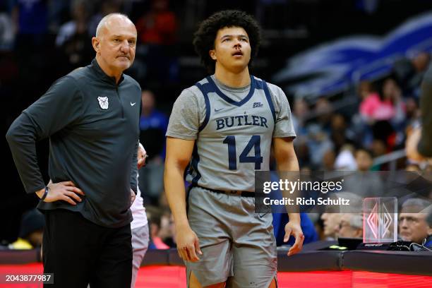 Landon Moore of the Butler Bulldogs walks off the court after being elbowed in the nose as head coach Thad Matta looks on during a game against the...