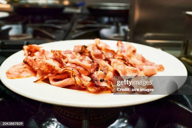 smoked ham served on a plate on the kitchen of a house in the foreground without people, front view - tocino ahumado fotografías e imágenes de stock
