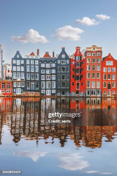 typical dutch houses reflections on the water of the canal on a sunny day - amstel stock pictures, royalty-free photos & images