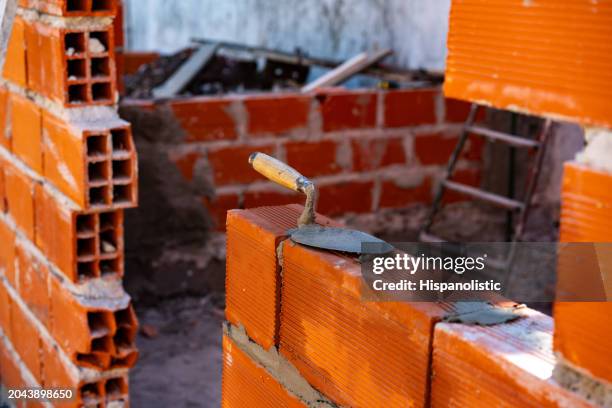 construction of a brick wall in process - construction industry concepts - contracting stock pictures, royalty-free photos & images