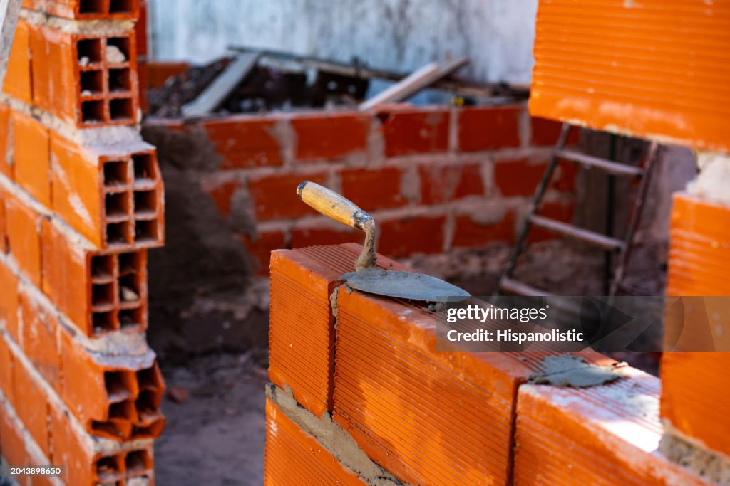 Construction of a brick wall in process - Construction industry concepts