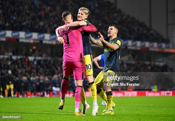 Martin Dubravka of Newcastle United celebrates with teammates Anthony Gordon and Bruno Guimaraes after saving the fifth and decisive penalty from...