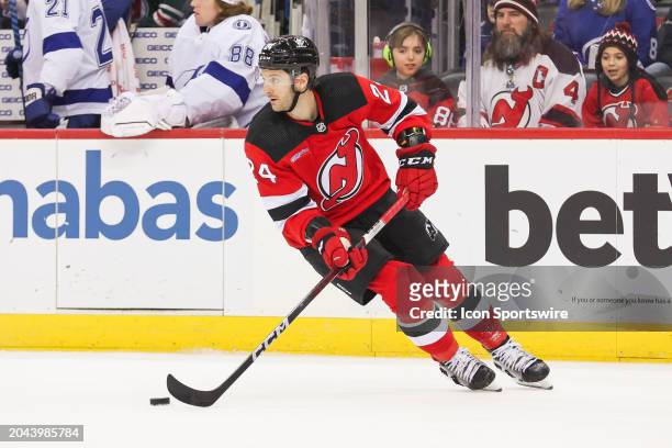 New Jersey Devils defenseman Colin Miller skates with the puck during a game between the against the against the Tampa Bay Lightning and New Jersey...