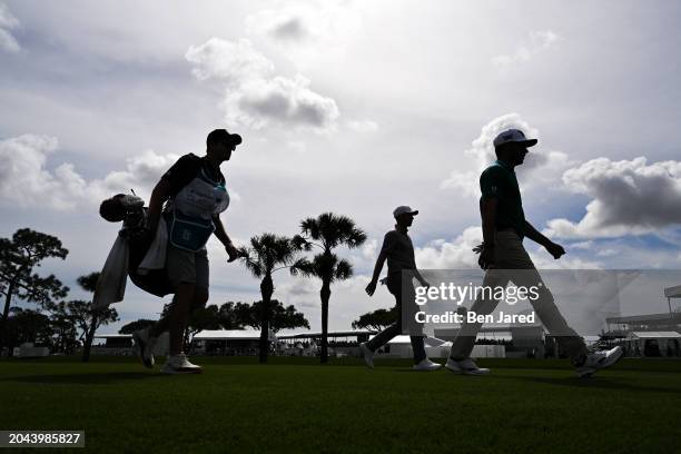 Eric Cole, Daniel Berger and a caddie walk along the fourth tee box during the second round of Cognizant Classic in The Palm Beaches at PGA National...