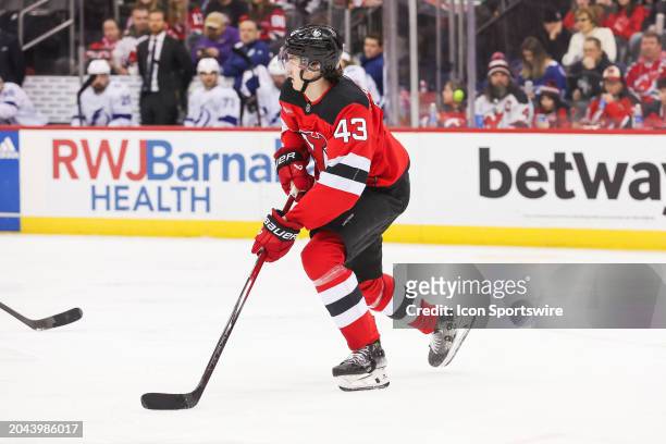 New Jersey Devils defenseman Luke Hughes skates with the puck during a game between the against the against the Tampa Bay Lightning and New Jersey...