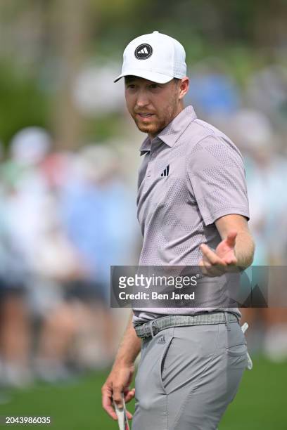 Daniel Berger talks with his caddie on the third green during the second round of Cognizant Classic in The Palm Beaches at PGA National Resort the...