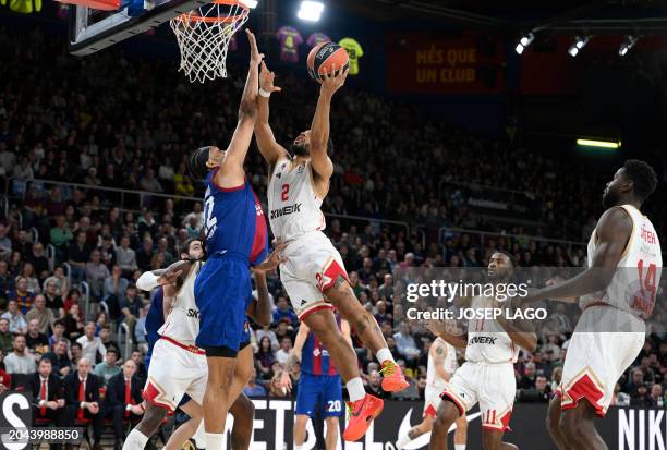 Monaco's French guard Elie Okobo puts up a shot to the basket against Barcelona's American forward Jabari Parker during the Euroleague basketball...