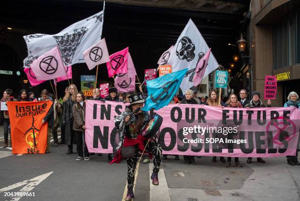 Protesters hold placards, flags and a banner during the demonstration. Extinction Rebellion organised a week long campaign together with other...