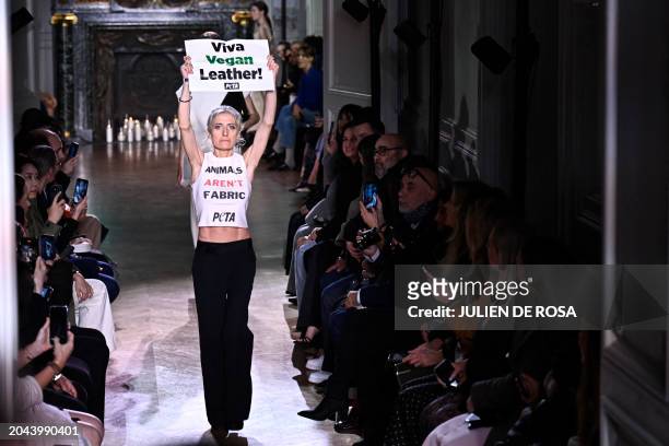 An activist of People for the Ethical Treatment of Animals takes to the catwalk to protest against the use of leather in the fashion industry, as...