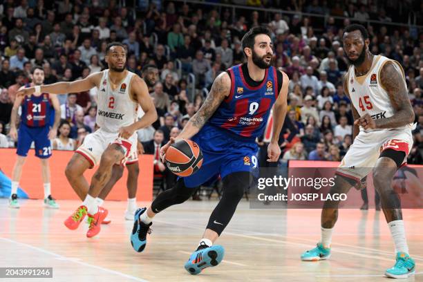 Barcelona's Spanish guard Ricky Rubio drives the ball against AS Monaco's French guard Elie Okobo and AS Monaco's American centre Donta Hall during...