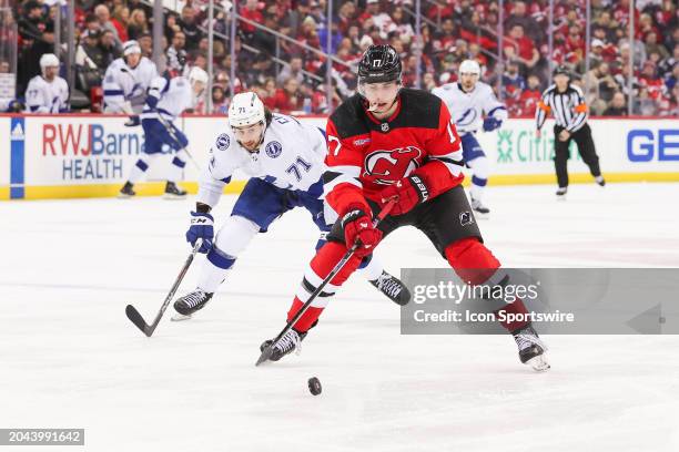 New Jersey Devils defenseman Simon Nemec skates with the puck while being chased by Tampa Bay Lightning center Anthony Cirelli during a game between...