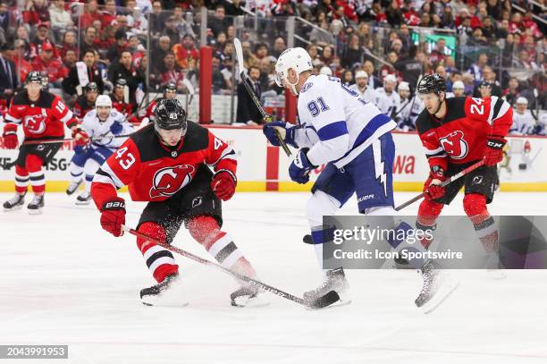 Tampa Bay Lightning center Steven Stamkos skates while being defended by New Jersey Devils defenseman Luke Hughes during a game between the against...