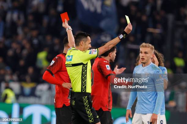 Referee Marco Di Bello is showing a red card to Marcos Antonio of Lazio during the Serie A soccer match between SS Lazio and AC Milan at Stadio...