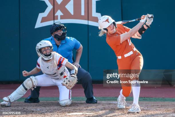 Texas catcher Reese Atwood watches her homerun ball head for the fence during the college softball game between Texas Longhorns and Northwestern...
