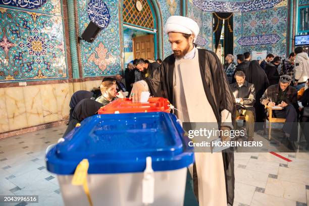 Iranians participate in the 12th term parliamentary elections and the 6th term Assembly of Leadership Experts' voting at a Tehran polling station on...