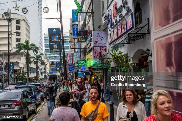 Pedestrians along a road in Kuala Lumpur, Malaysia, on Friday, Feb. 23, 2024. Malaysia's varied attractions now have added appeal thanks to the weak...