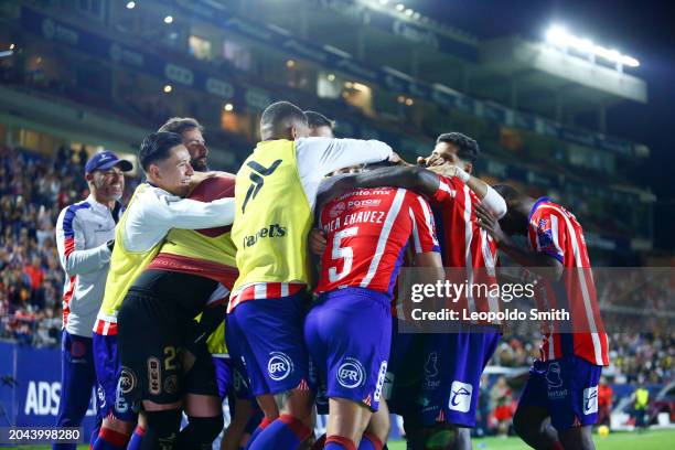 BenjamIn Galdames of Atletico San Luis celebrates with teammates after scoring the team's third goal during the 10th round match between Atletico San...