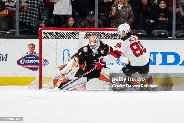 Goaltender Lukas Dostal of the Anaheim Ducks makes a save on the penalty shot of Jack Hughes of the New Jersey Devils with three seconds remaining in...