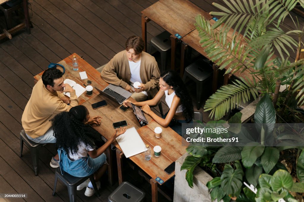 College friends studying together at coffee shop