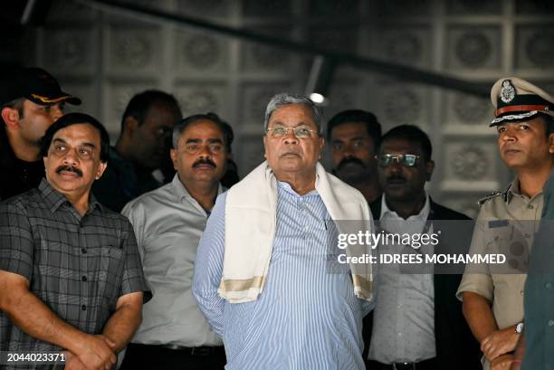 Siddaramaiah , Chief Minister of India's Karnataka state is briefed by police personnel as they inspect the site of a bomb blast at Rameshwaram Cafe...