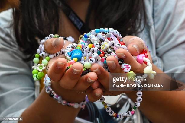 Fan of US singer Taylor Swift, also known as a Swiftie, holds friendship bracelets as she arrives for the first of the pop star's six sold-out Eras...