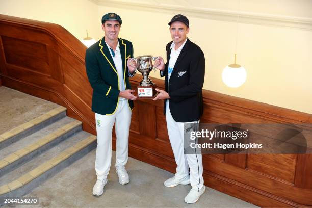 Pat Cummins of Australia and Tim Southee of New Zealand pose with the test series trophy during a nets session ahead of the First Test in the series...