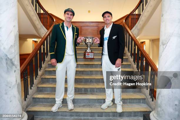 Pat Cummins of Australia and Tim Southee of New Zealand pose with the test series trophy during a nets session ahead of the First Test in the series...