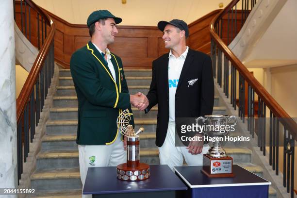 Pat Cummins of Australia and Tim Southee of New Zealand pose with the test series and Trans-Tasman trophies during a nets session ahead of the First...