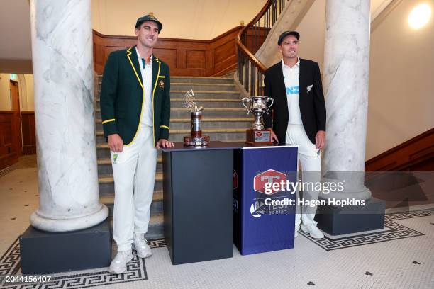 Pat Cummins of Australia and Tim Southee of New Zealand pose with the test series and Trans-Tasman trophies during a nets session ahead of the First...