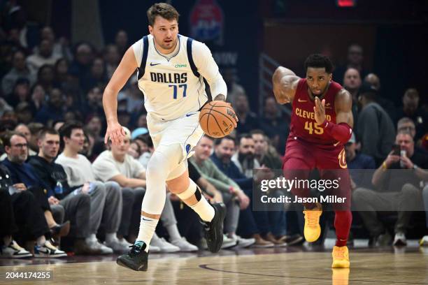 Luka Doncic of the Dallas Mavericks brings the ball up court after a steal from Donovan Mitchell of the Cleveland Cavaliers during the first quarter...