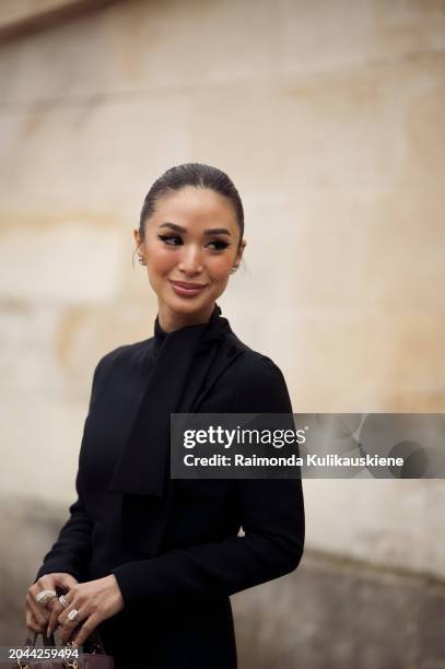 Heart Evangelista wears black maxi dress and dirty pink Dior bag outside Dior during the Womenswear Fall/Winter 2024/2025 as part of Paris Fashion...