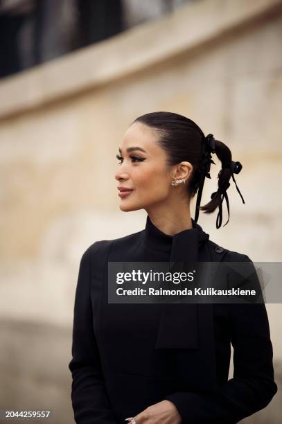 Heart Evangelista wears black maxi dress and dirty pink Dior bag outside Dior during the Womenswear Fall/Winter 2024/2025 as part of Paris Fashion...