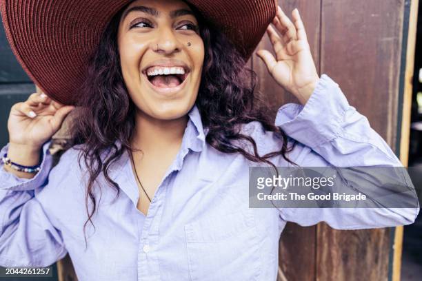 happy young woman wearing hat - blue blouse stock pictures, royalty-free photos & images