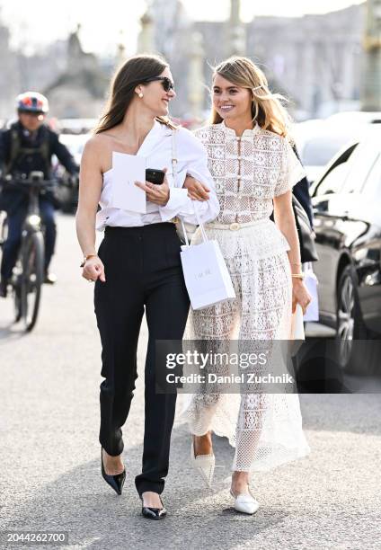 Anne-Laure Mais is seen wearing a white asymmetric button shirt, black high waisted pants, white bag, black sunglasses with Claire Rose Cliteur...