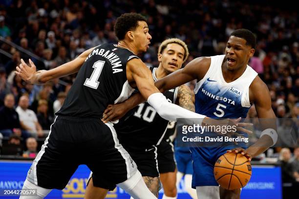 Anthony Edwards of the Minnesota Timberwolves drives to the basket against Victor Wembanyama of the San Antonio Spurs in the first quarter at Target...