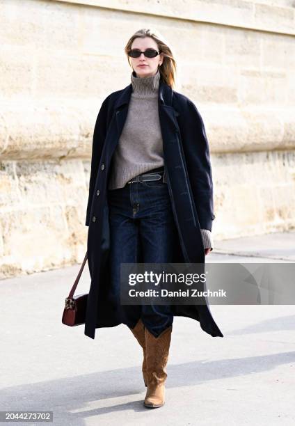 Model Ieva Palionyte is seen wearing a black coat, gray sweater, blue jeans and brown cowboy boots outside the Dior show during the Womenswear...